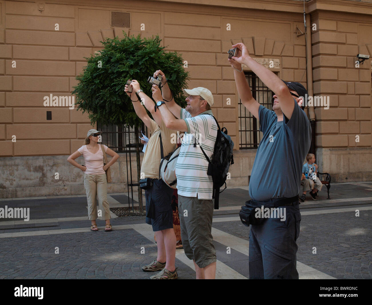 Photographers with their pocket cameras taking pictures on a pedestrian street in Budapest, Hungary Stock Photo