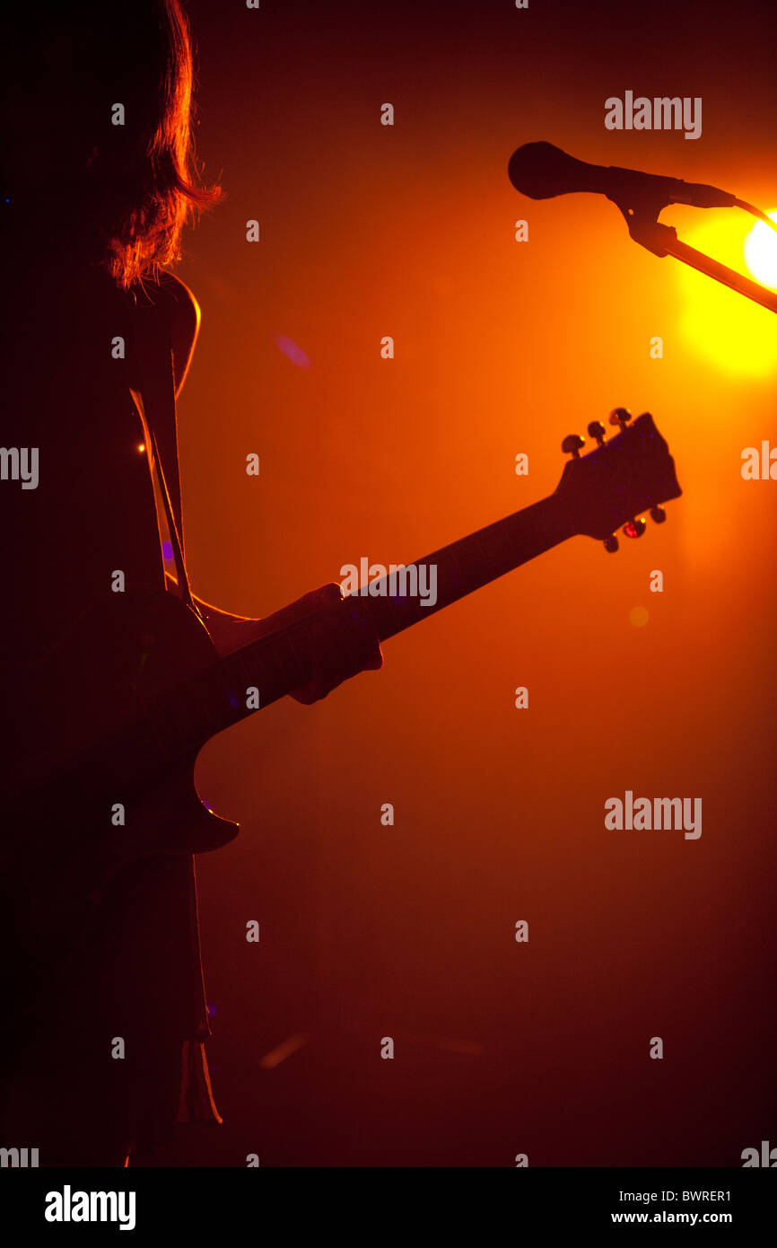 Guitarist on stage playing a live concert, with guitar. Stock Photo