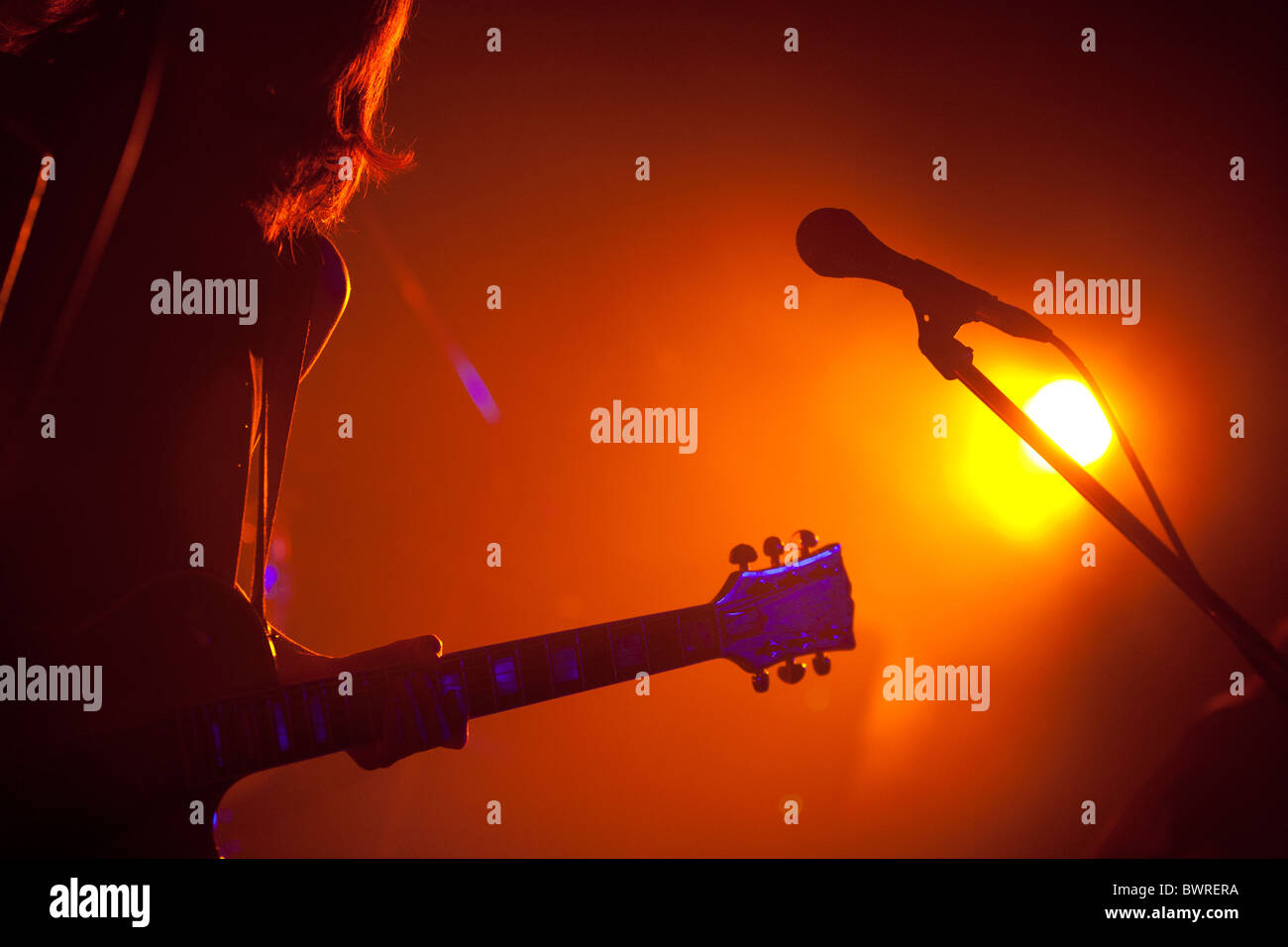 Guitarist on stage playing a live concert, with guitar. Stock Photo