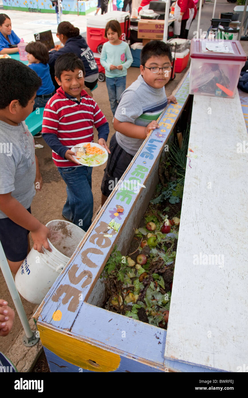 Young boys collect food for the worm compost bin after class mates eat