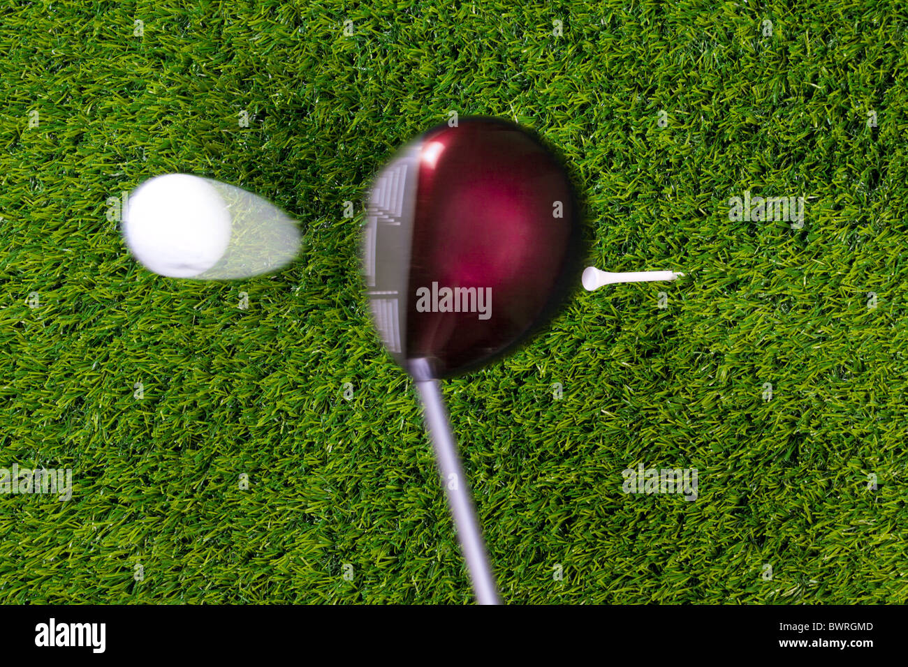 Photo of a driver hitting a golf ball off the tee with motion blur on