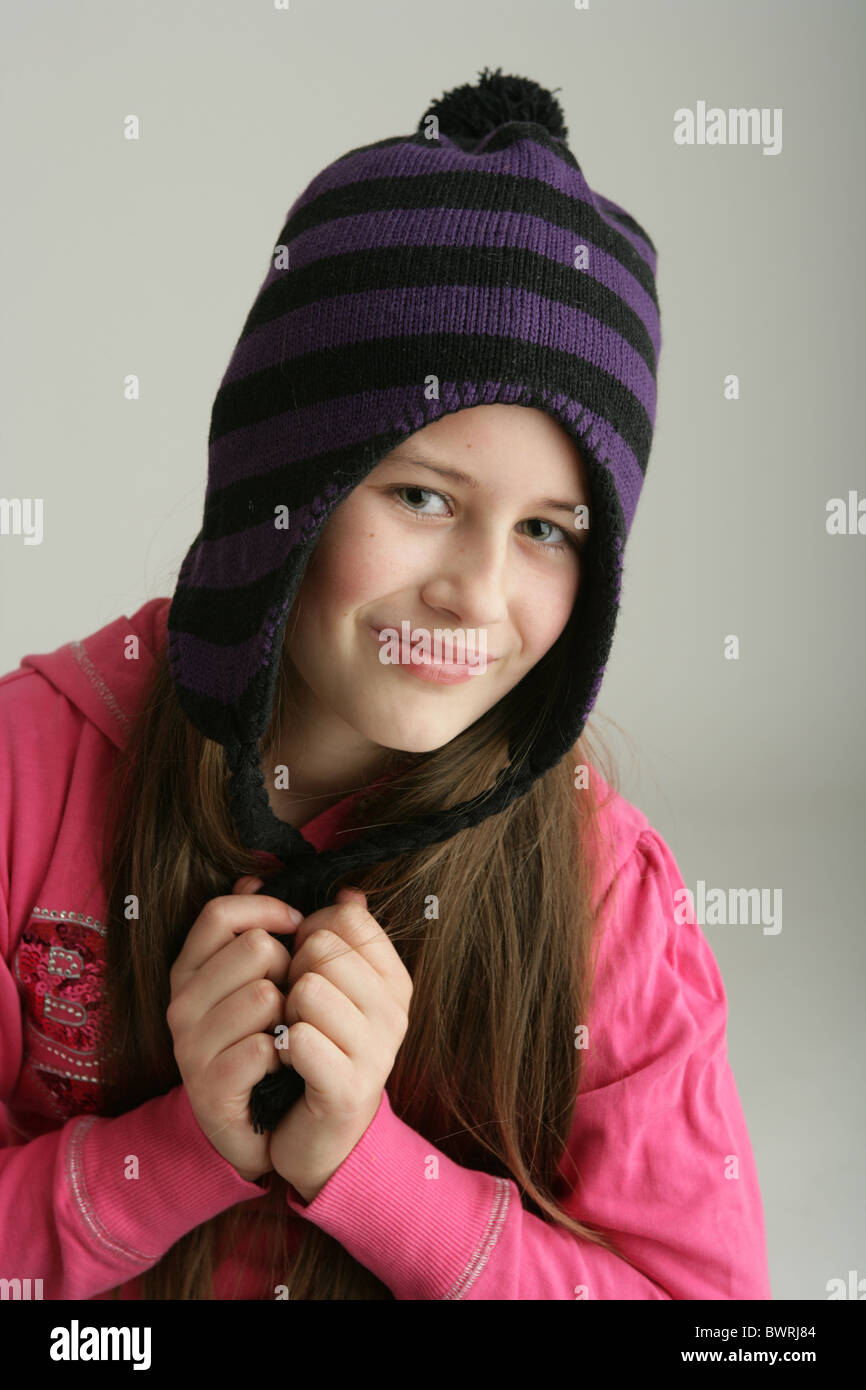 Portrait of a ten year old girl wearing a stripy woolly hat Stock Photo