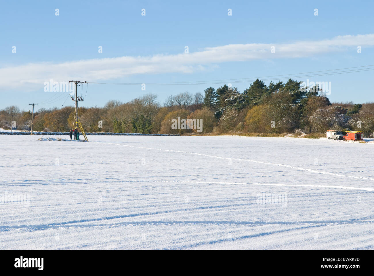 Electricity supply company E-On employers working on a 11kV overhead line during the winter after a snowy weather. Stock Photo