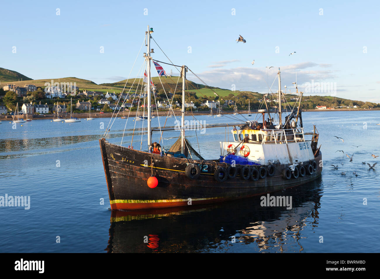 A fishing boat entering the harbour in Campbeltown Loch, Campbeltown on the Kintyre peninsula, Argyll & Bute, Scotland Stock Photo