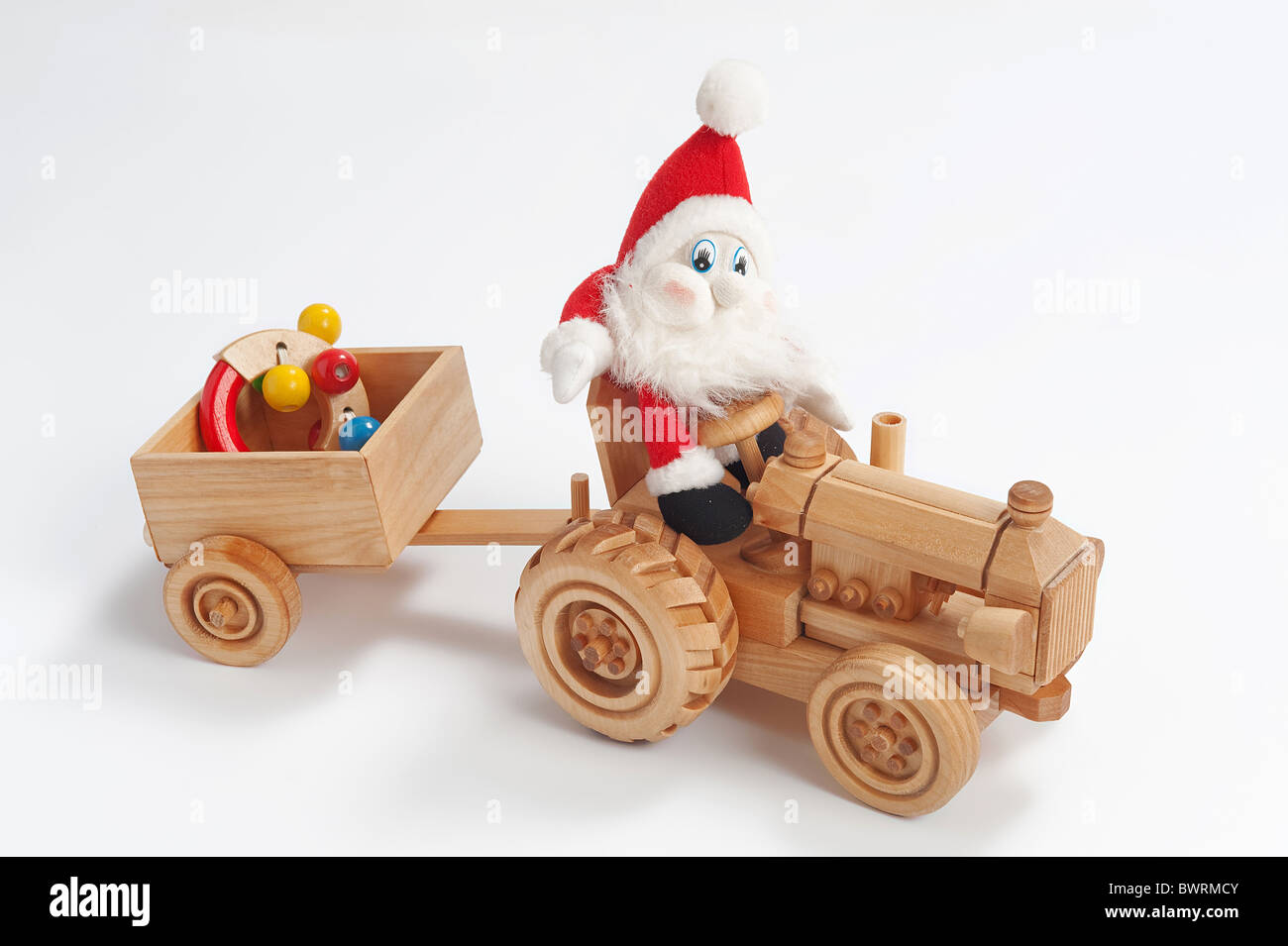 Gnome driving tractor with christmas toy in trailer Stock Photo Alamy