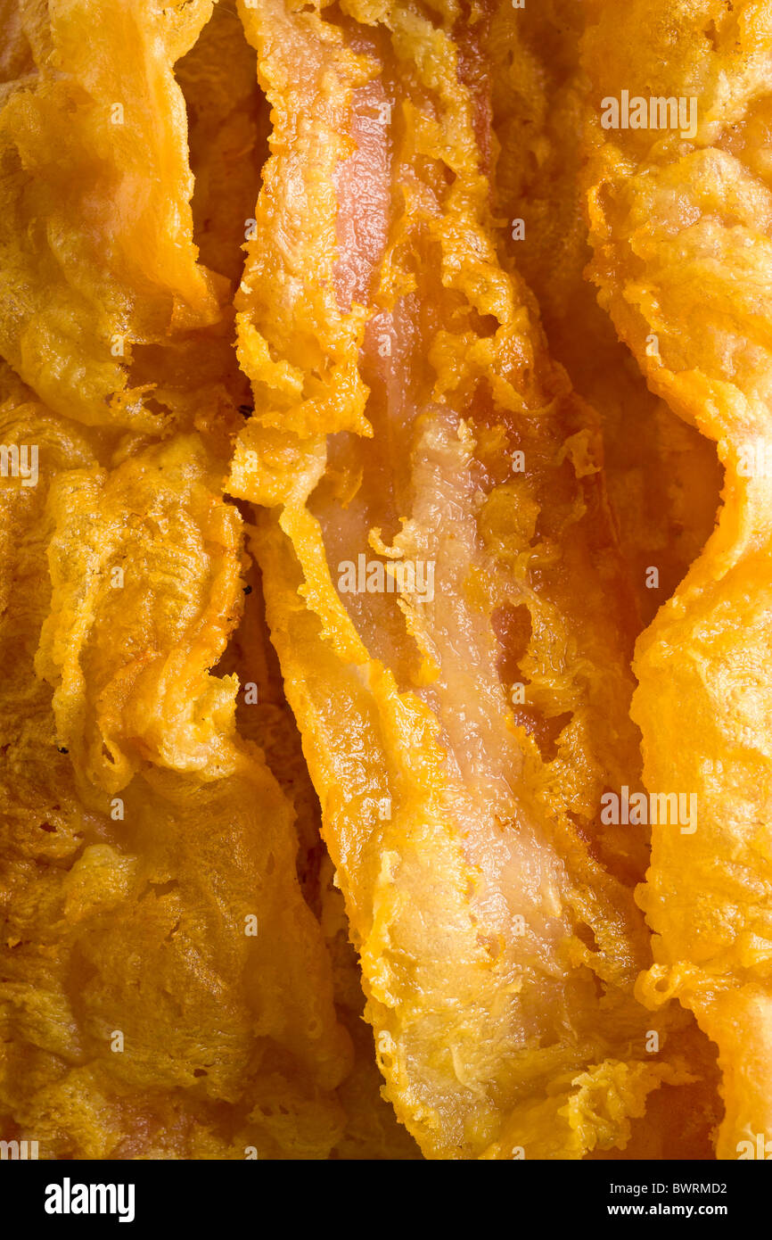 Chicken-Fried Bacon - Bacon slices dipped in a batter of whole dry milk and water, tossed in flour and deep fried. Stock Photo