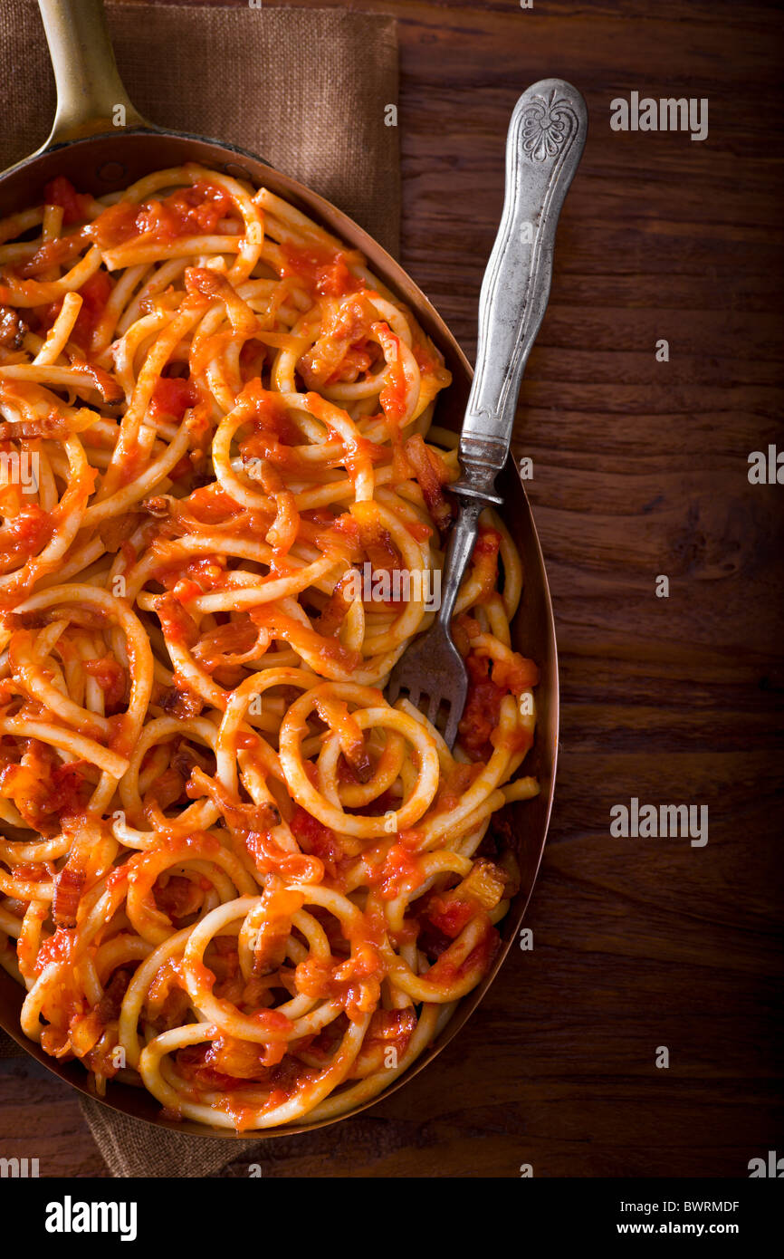 Pasta with Guanciale, Onions, Tomato, Red Chili Flakes and Pecorino Cheese. Stock Photo