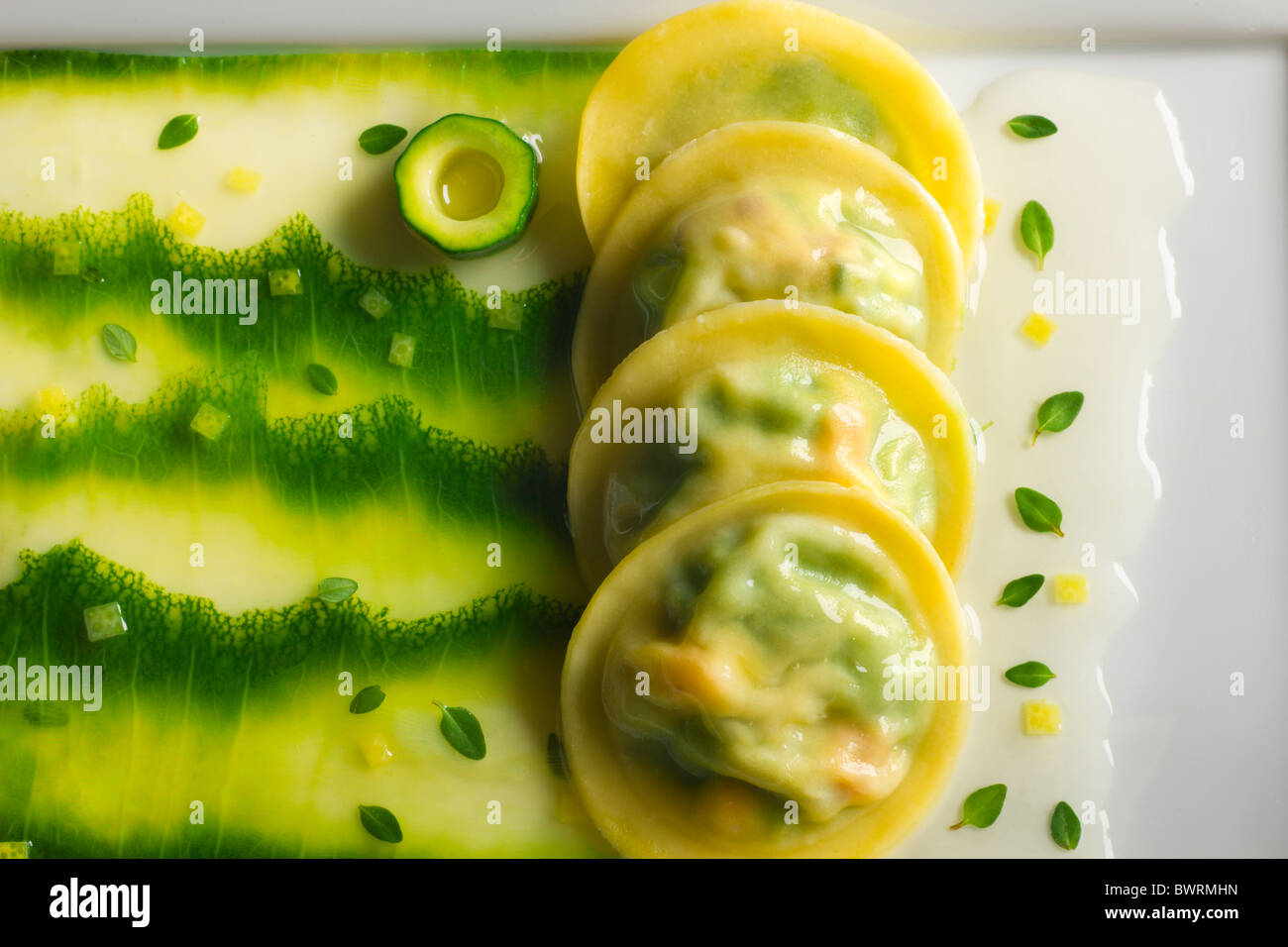Ravioli stuffed with Zucchini and Cheese with a Lemon-Thyme Essence prepared by Tony Esnault, Executive Chef of Adour at The St. Stock Photo