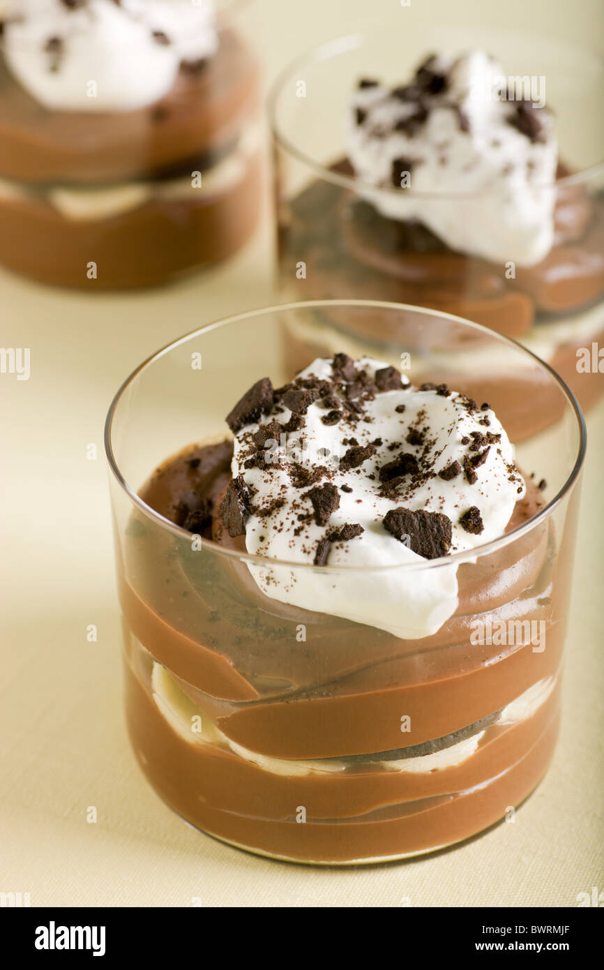 Milk Chocolate Banana Pudding with Whipped Cream and Chocolate Wafer Cookie Crumbs Stock Photo