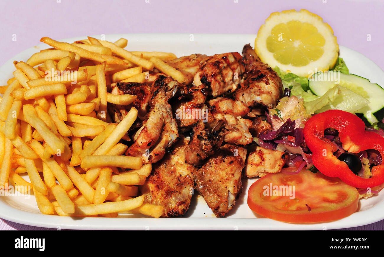 Chicken Piri-Piri (peri-peri) with French fries Stock Photo