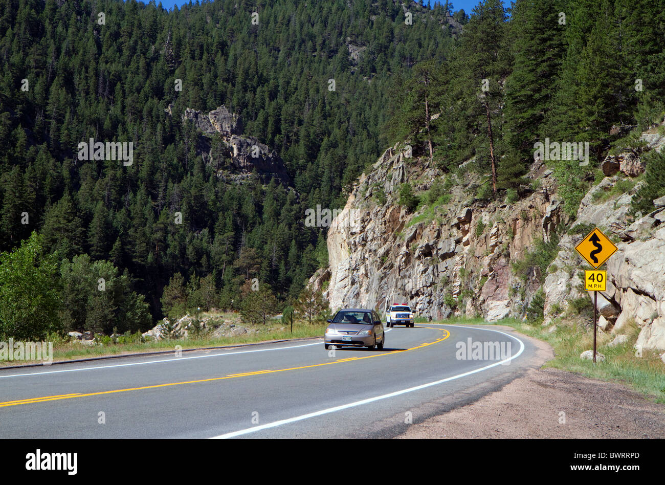Automobiles travel along U.S. Route 34 through Big Thompson Canyon near Loveland, Colorado, USA. Stock Photo