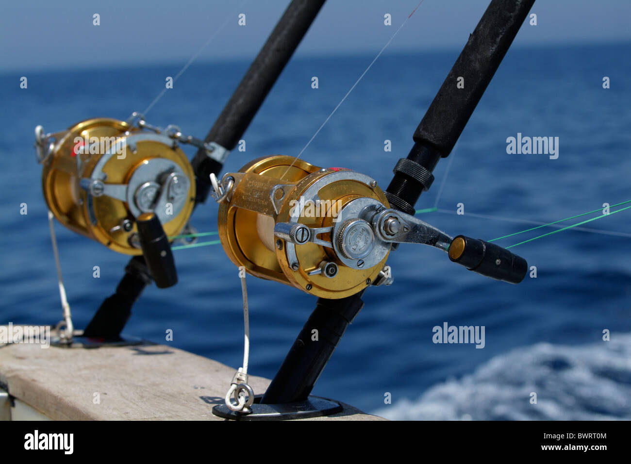 Two fishing rods and reels on board a game fishing boat in the Mediterranean Sea, France. Stock Photo