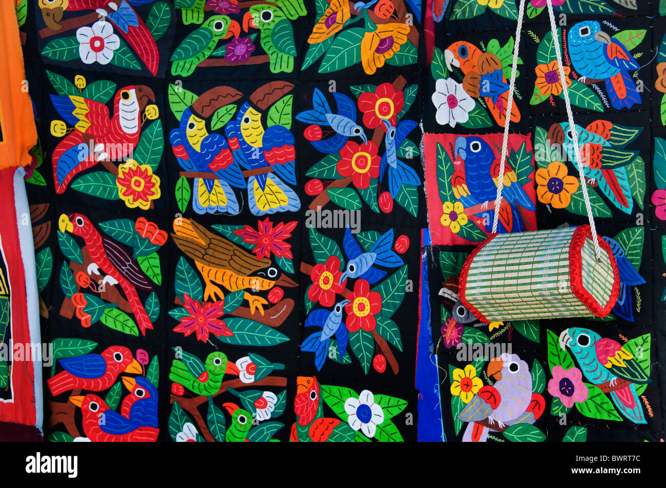 Bright colorful mola textiles sewn by Kuna women are on display at a vendor's stall in Pedasi, Panama. Stock Photo