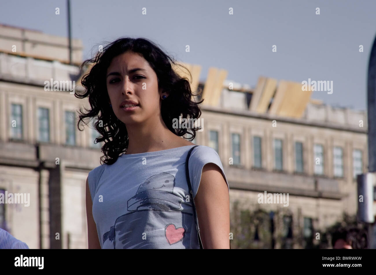 Young Mexican woman walking in the Zocalo of Mexico city Stock Photo