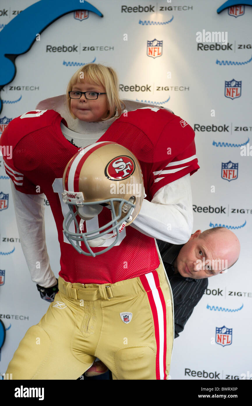 A young girl and her father pose for a portrait in a San Francisco 49er football uniform during the NFL rally at Trafalgar Stock Photo