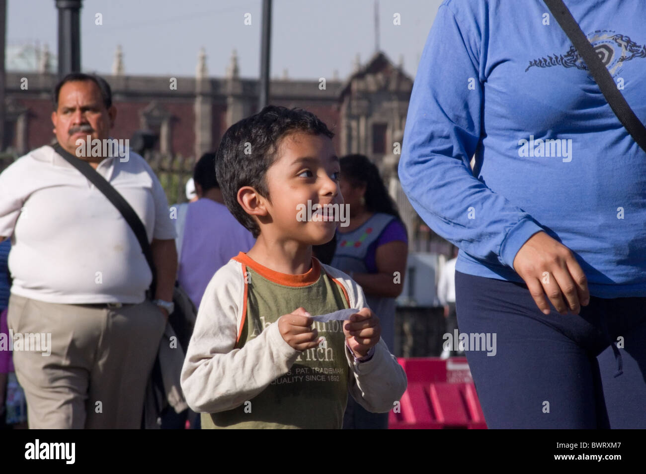 Happy Mexican kid walking with his parents in the streets of Mexico Stock Photo