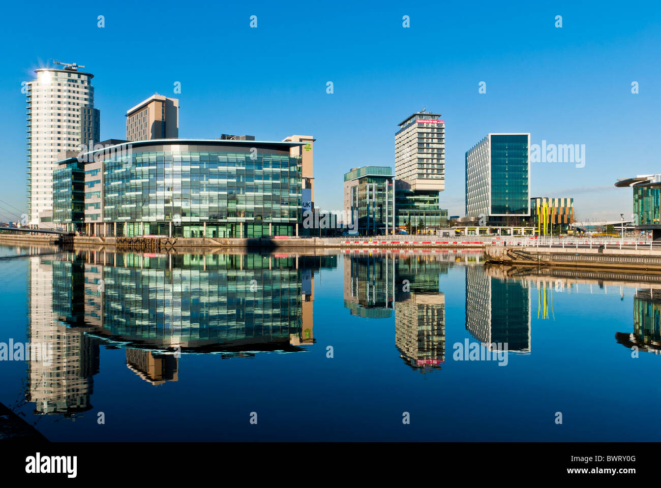 BBC Media City at Salford Quays reflected in docks, Manchester, England, UK Stock Photo