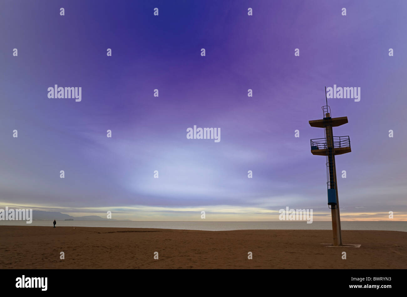 Man on Playamar beach, Torremolinos, Spain, at dawn. Stock Photo