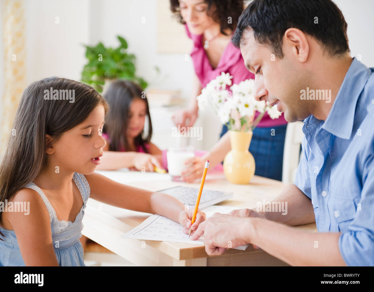 Parents helping children with homework Stock Photo - Alamy