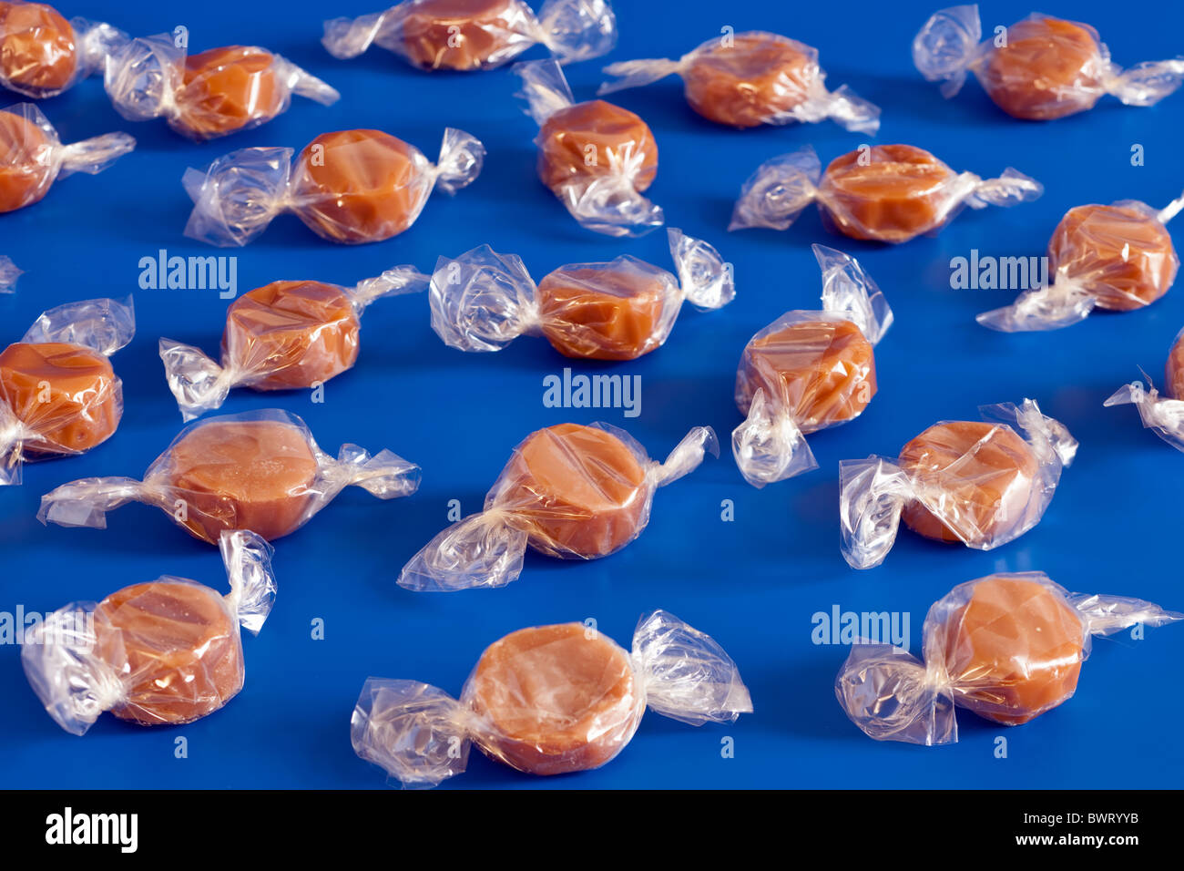Pile of clear cellophane wrapped toffee sweets Stock Photo