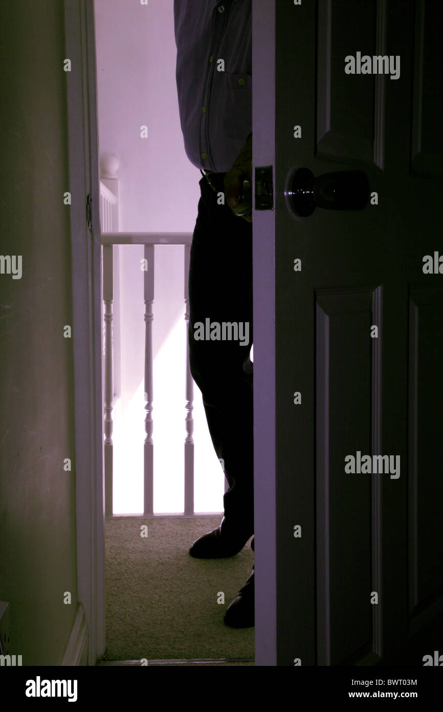 Man enter a dark room Stock Photo
