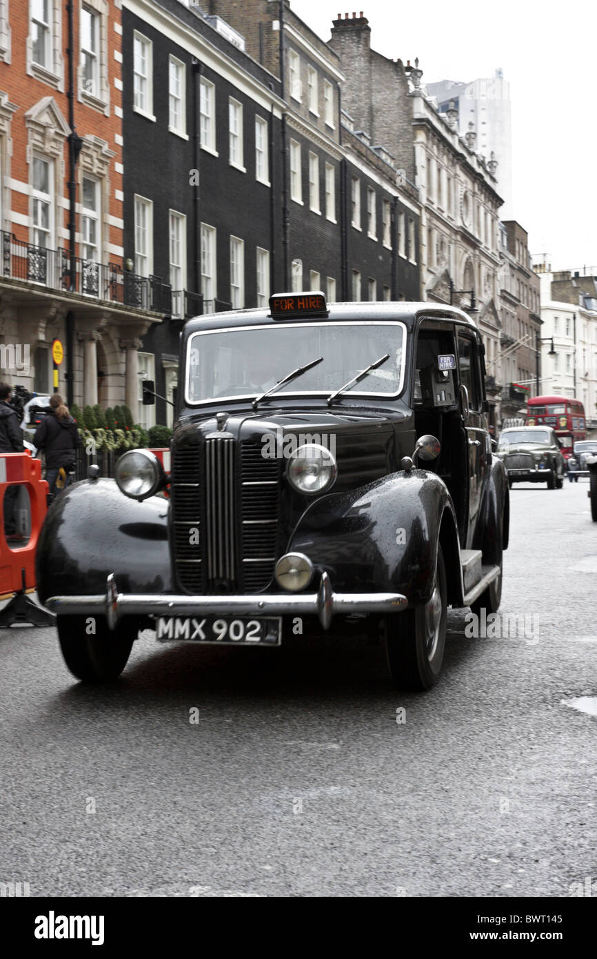 The iconic London Taxi, here viewed during the on location filming of A Week With Marolyn in Charles Street off Curzon Street. Stock Photo