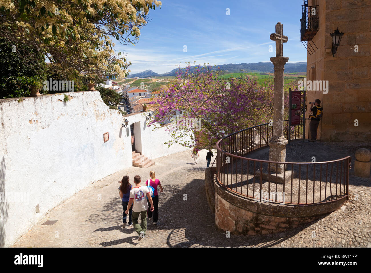 Ronda, Malaga Province, Spain. Tourists wandering down Calle Santo Domingo in the old city. Stock Photo