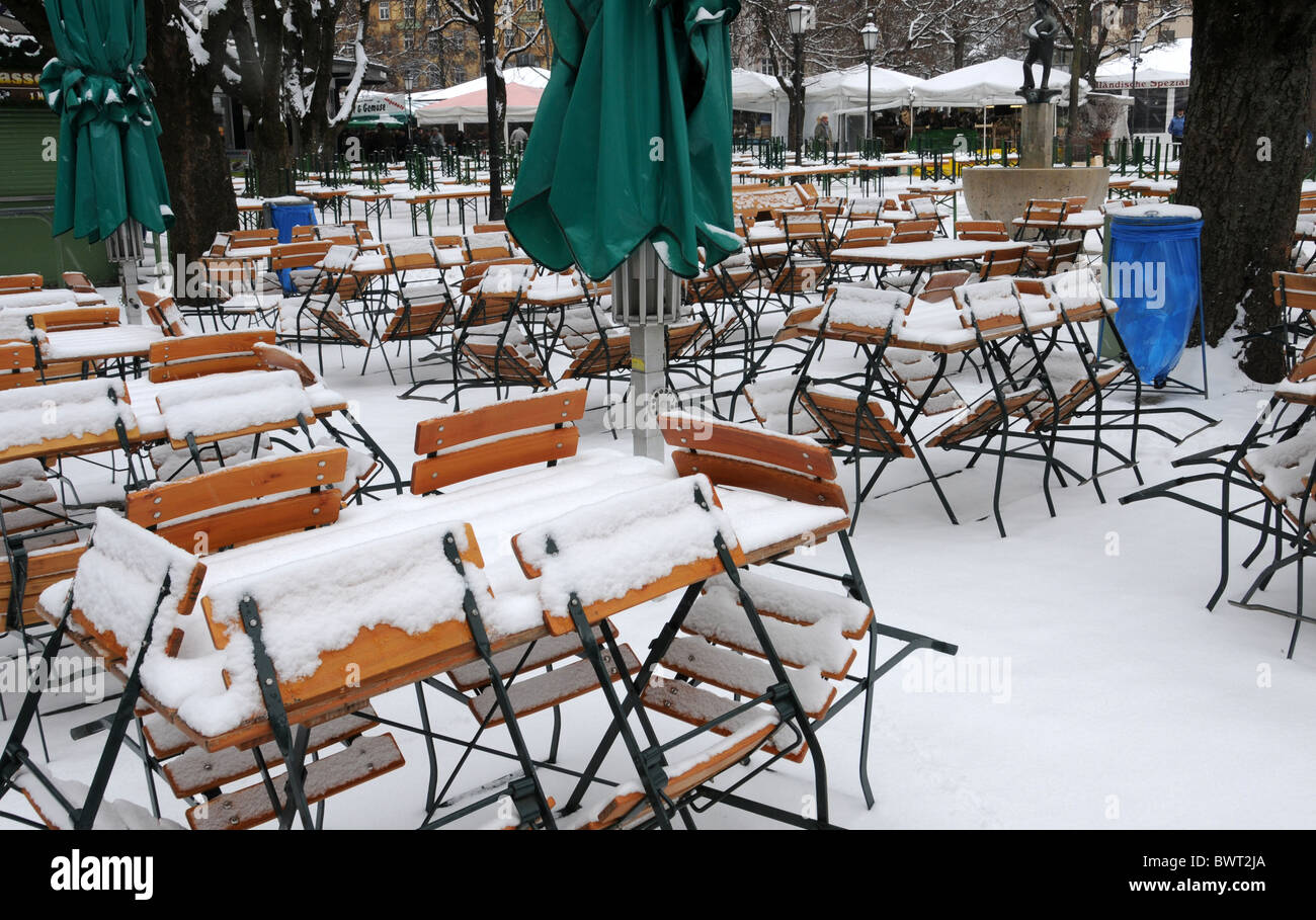Snow-covered beer garden in Munich Stock Photo