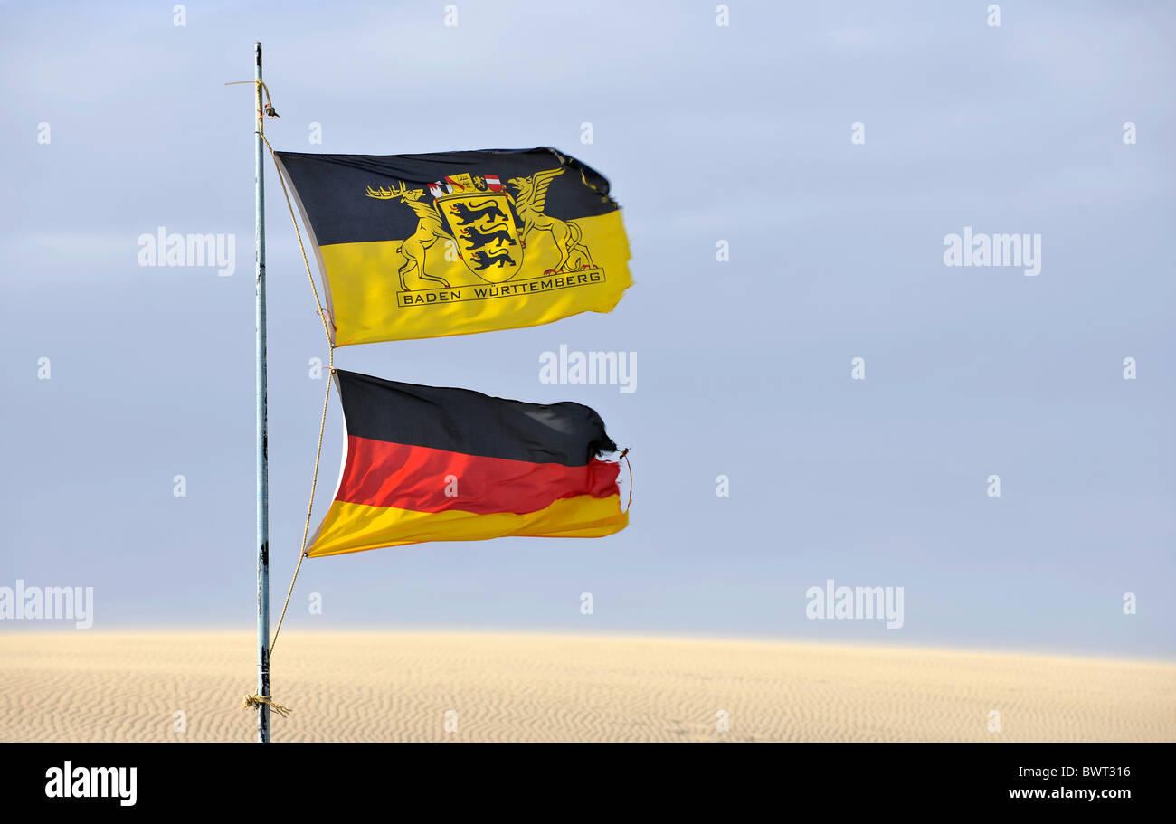Flags of Germany and Baden-Wuerttemberg blowing in the desert sand Stock Photo