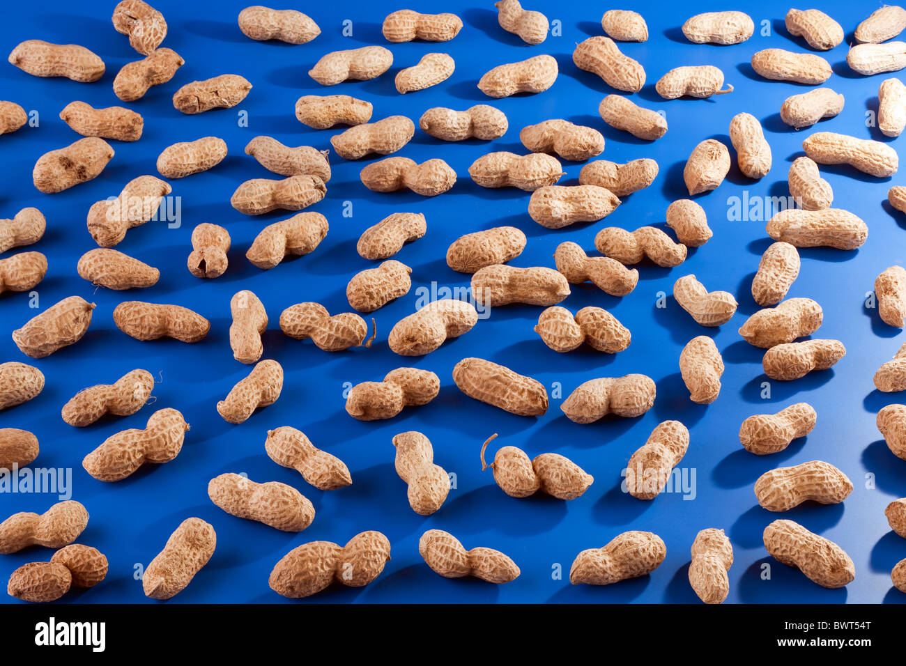Scattered roasted peanuts Stock Photo