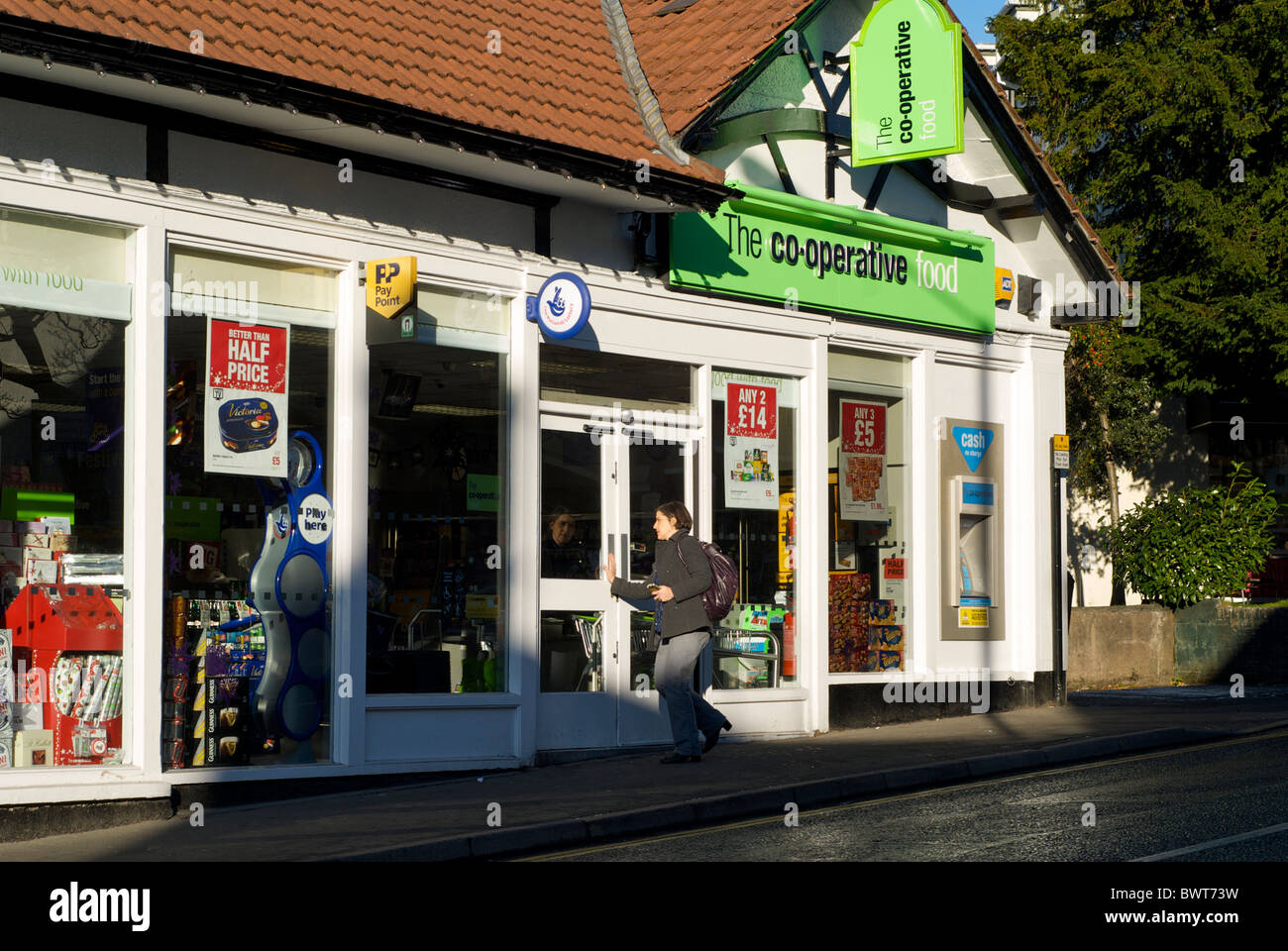 Woman going into cooperative store in Bowness, Lake District National