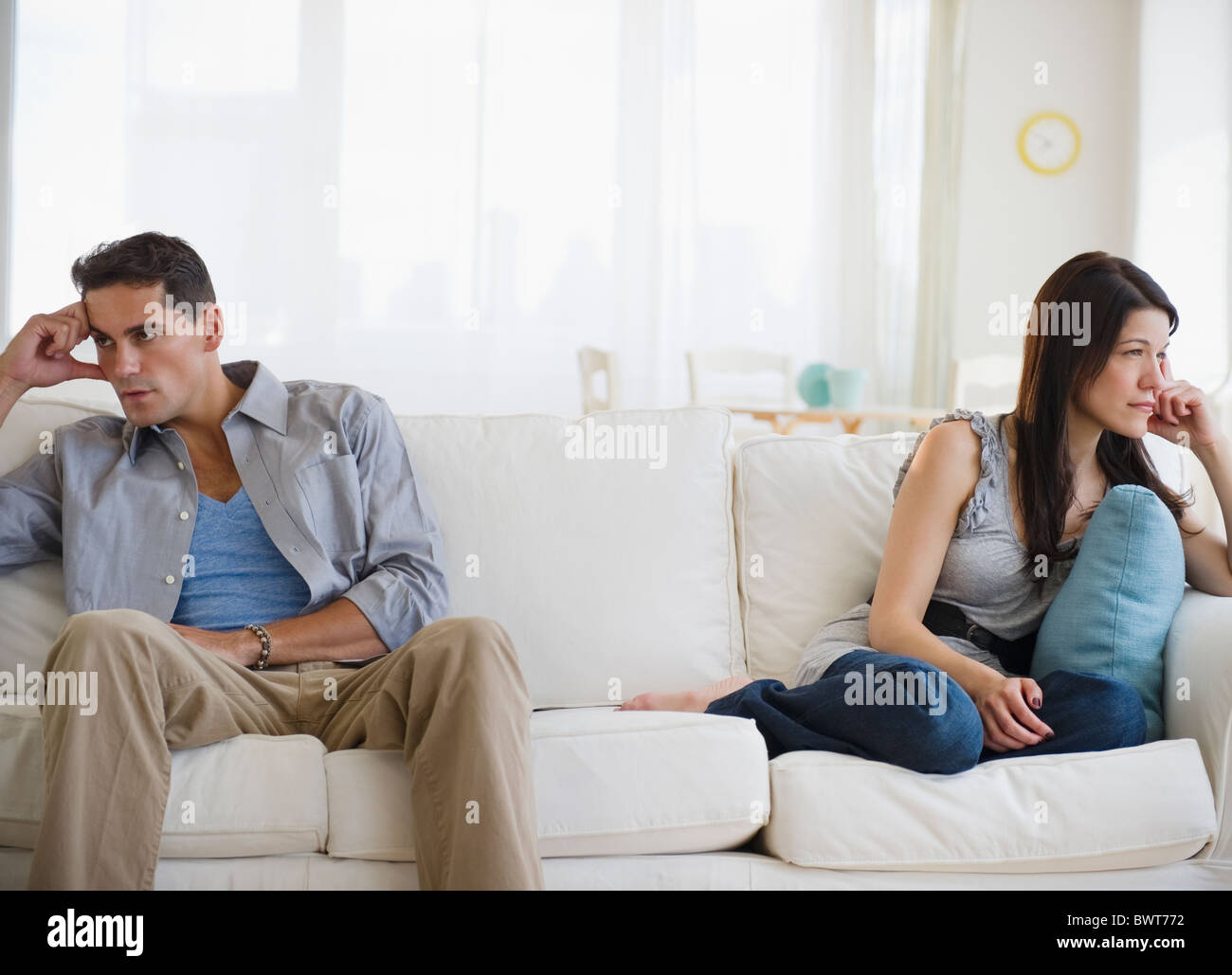 Angry mixed race couple having argument on sofa Stock Photo