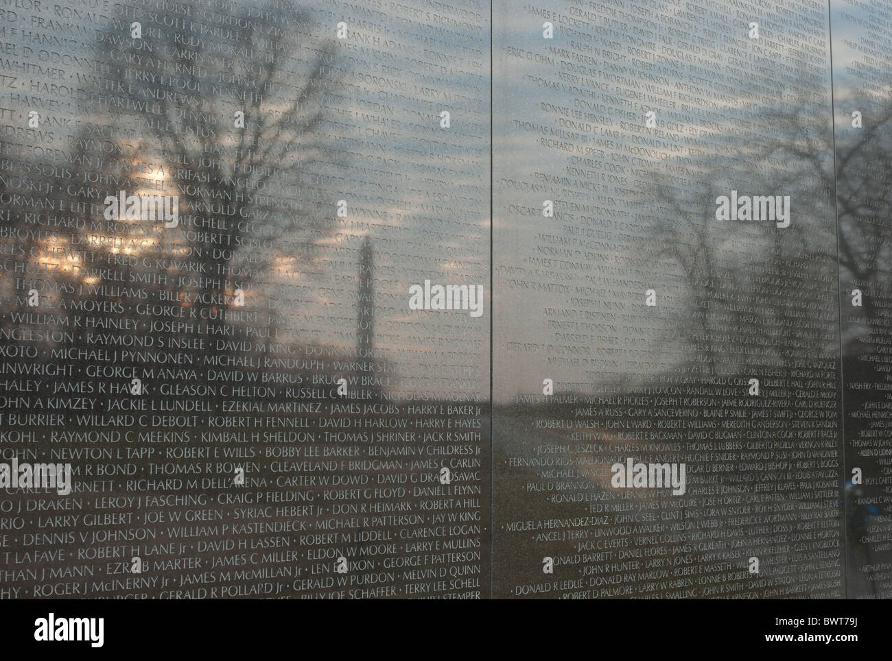 The Washington Monument reflected on the Vietnam Veterans Memorial wall in Washington, DC. Stock Photo