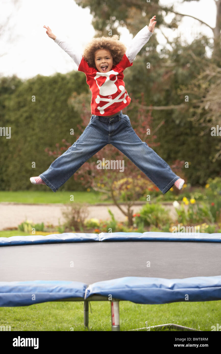 Boy Playing On Trampoline Stock Photo
