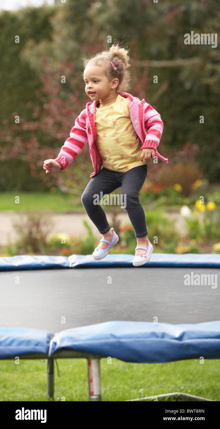 Girl Playing On Trampoline Stock Photo