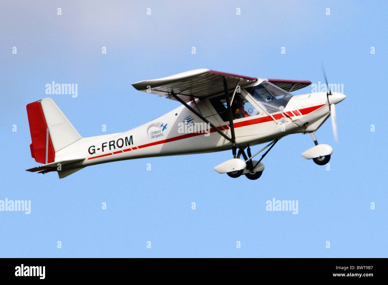 Ikarus C42 Cyclone FB100 microlight light plane climbing after take off from RAF Benson Stock Photo