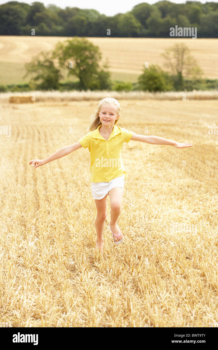Girl Running Through Summer Harvested Field Stock Photo
