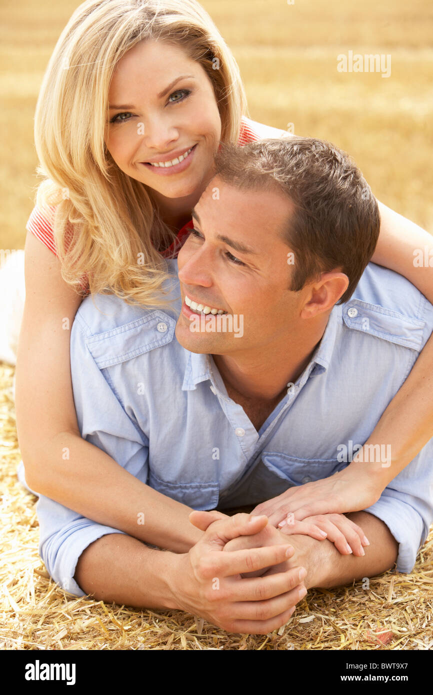 Couple Relaxing In Summer Harvested Field Stock Photo