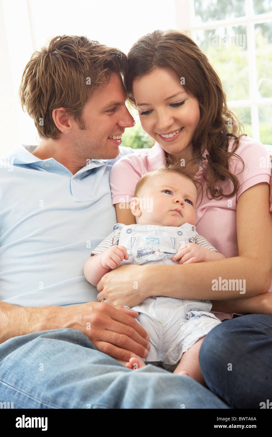 Parents Cuddling Newborn Baby Boy At Home Stock Photo Alamy