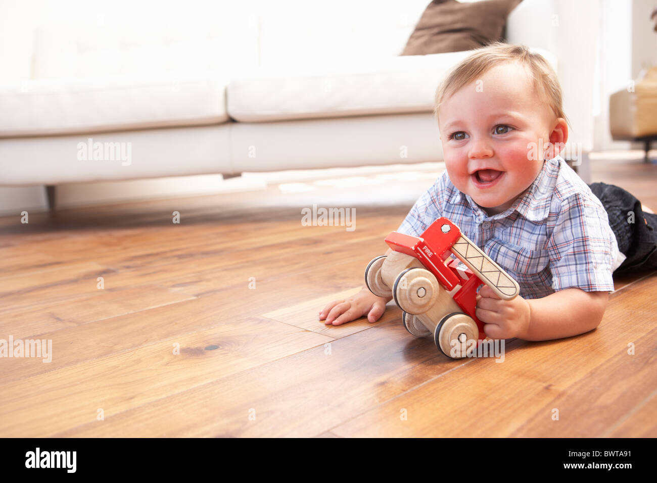 Young Boy Playing With Wooden Toy Car At Home Stock Photo - Alamy