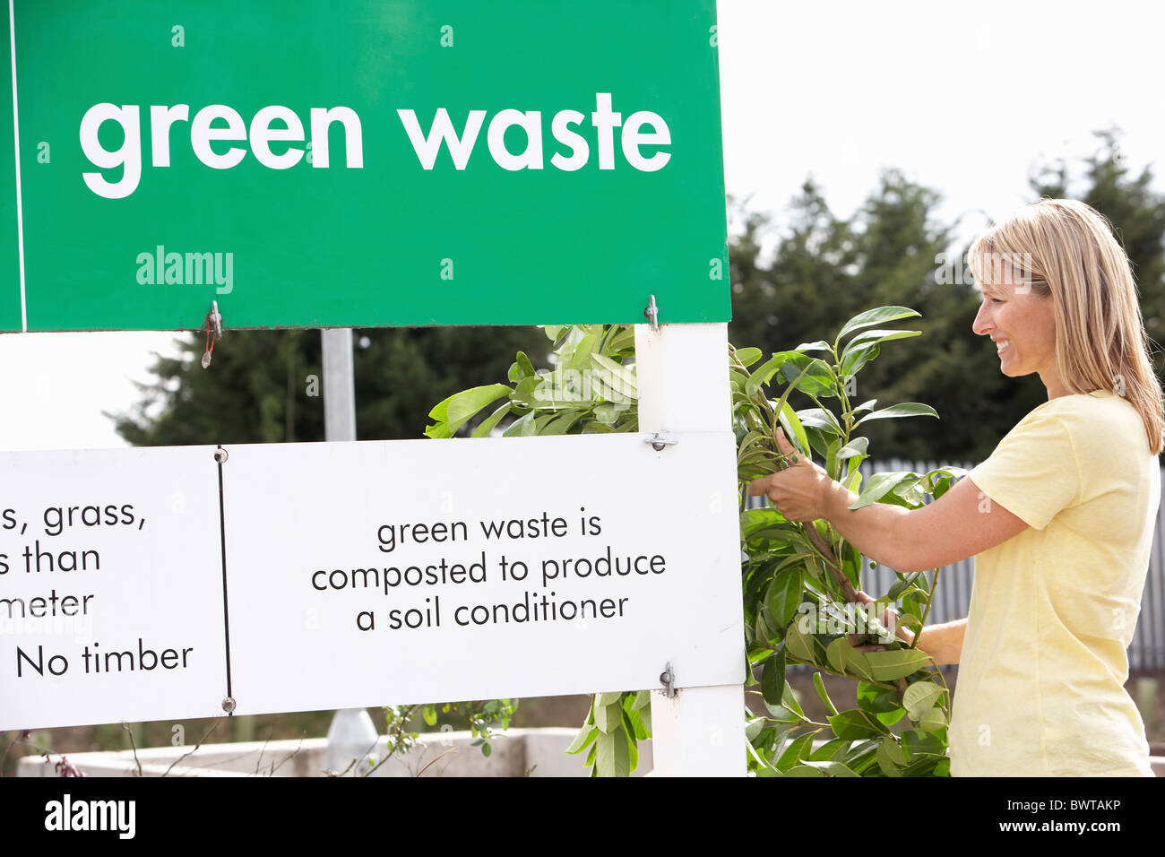 Man At Recycling Centre Disposing Of Garden Waste Stock Photo Alamy