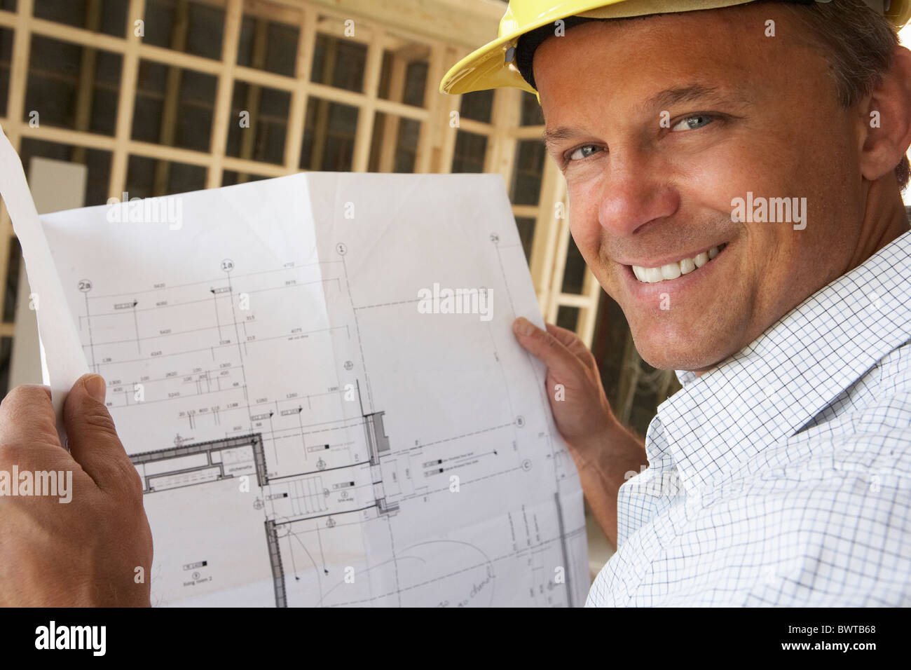 Architect With Plans In New Home Stock Photo