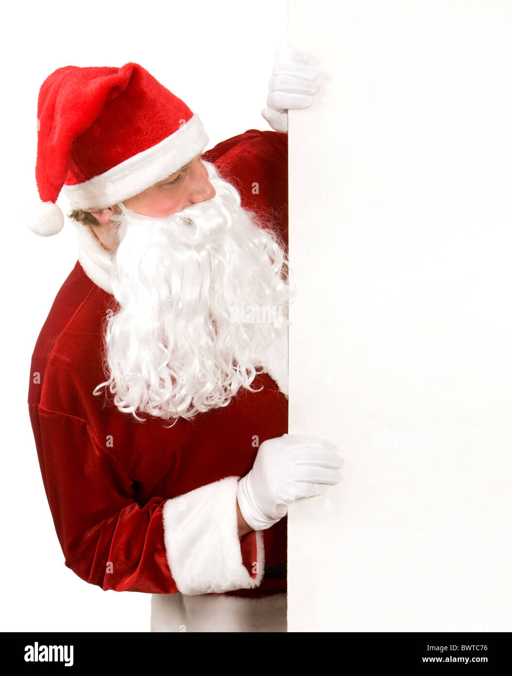 Photo of happy Santa Claus looking at blank board Stock Photo - Alamy