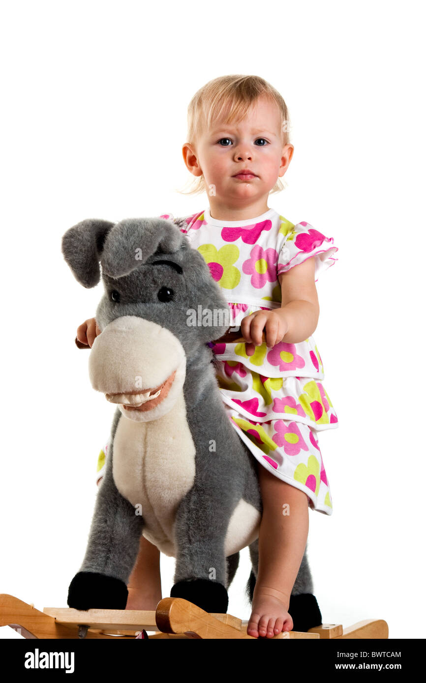 Baby swinging on a rocking donkey toy Stock Photo Alamy