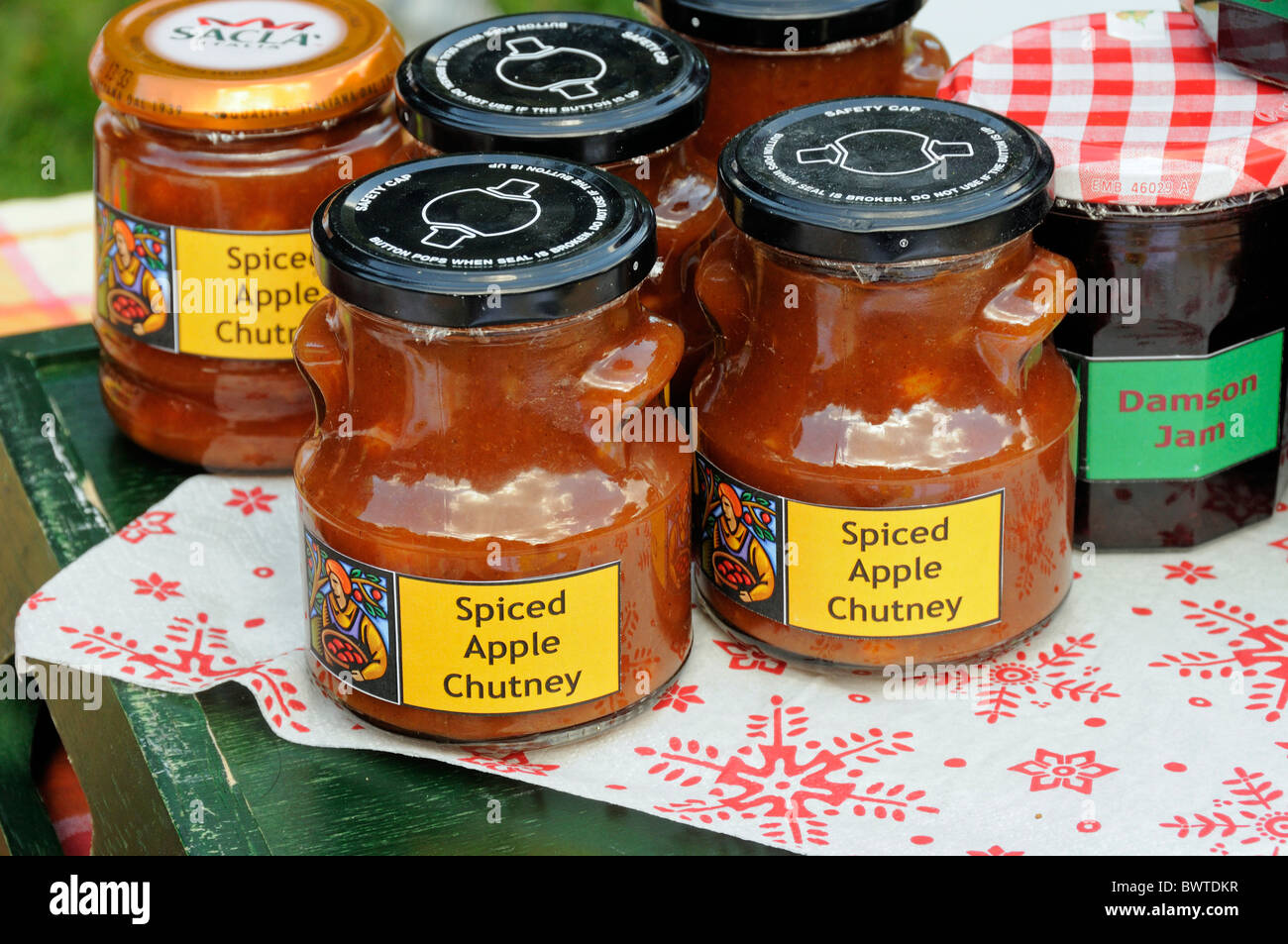 Jars of home made spiced apple chutney for sale on a stall Stock Photo