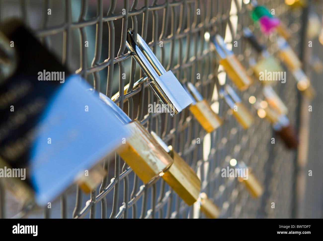 Love padlocks on a railing by the Tammerkoski rapids in Tampere Stock Photo