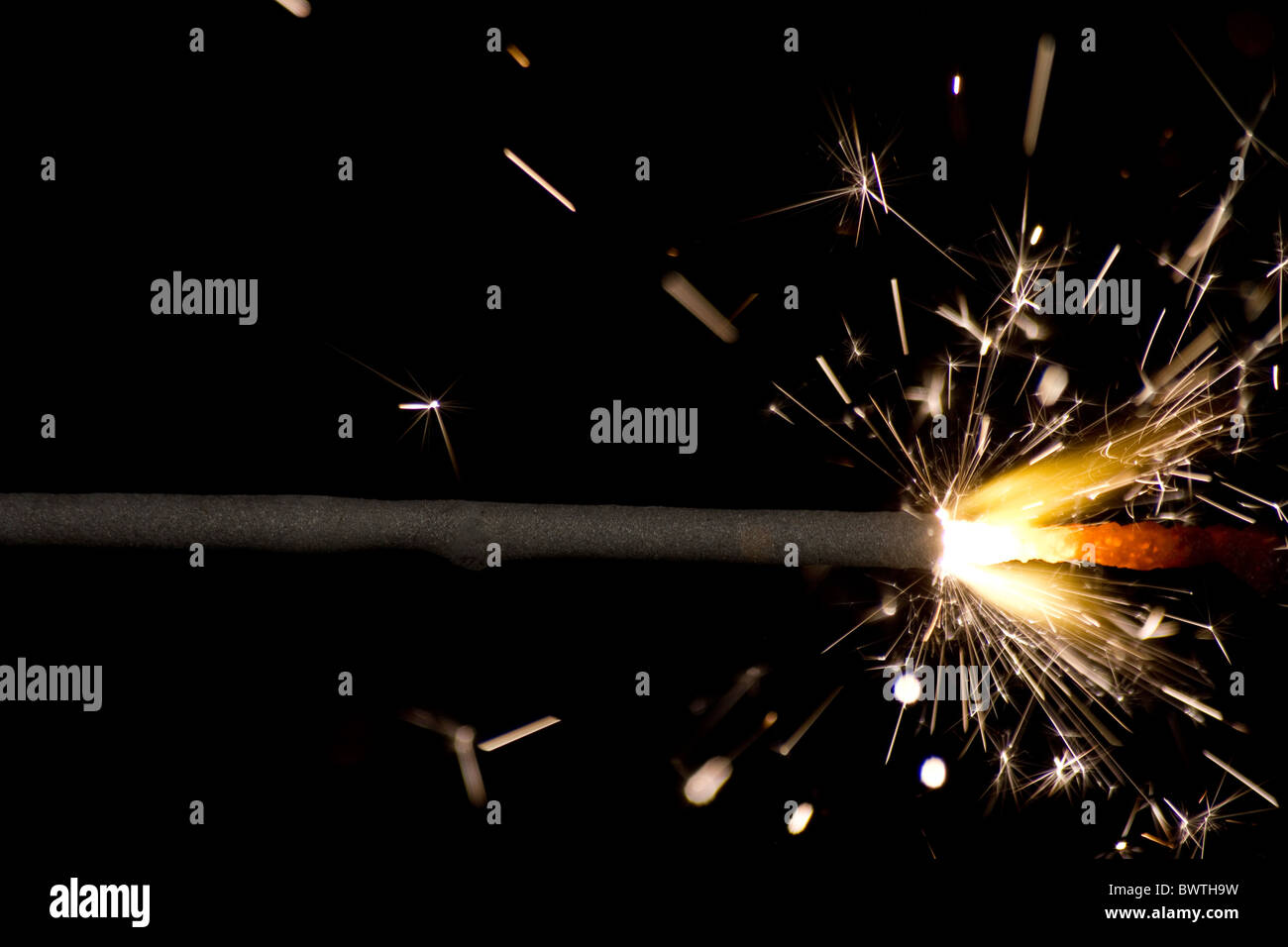 The picture shows a sparkler on black background . Stock Photo