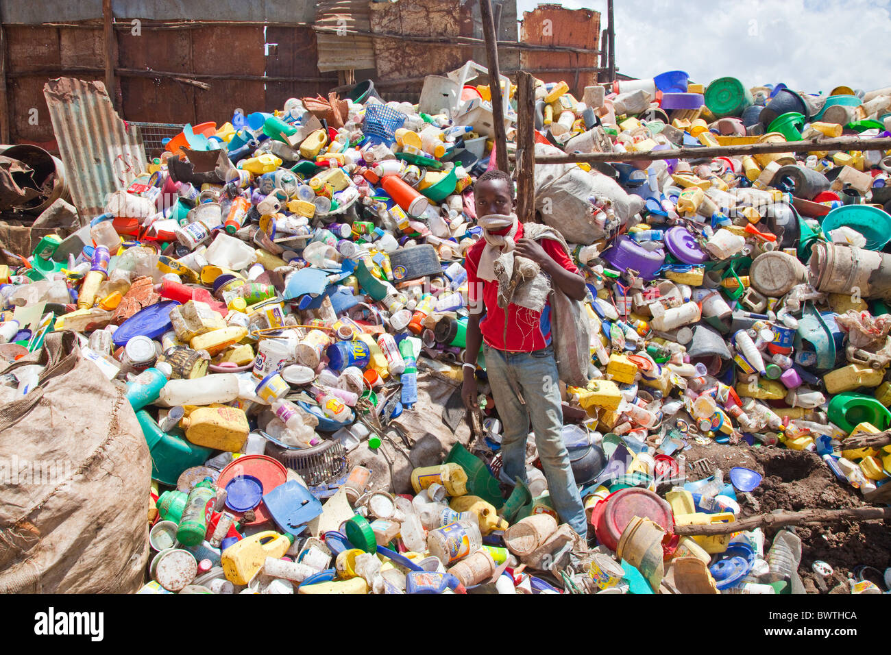 Boy scavenger at a recycling center in Nairobi, Kenya Stock Photo