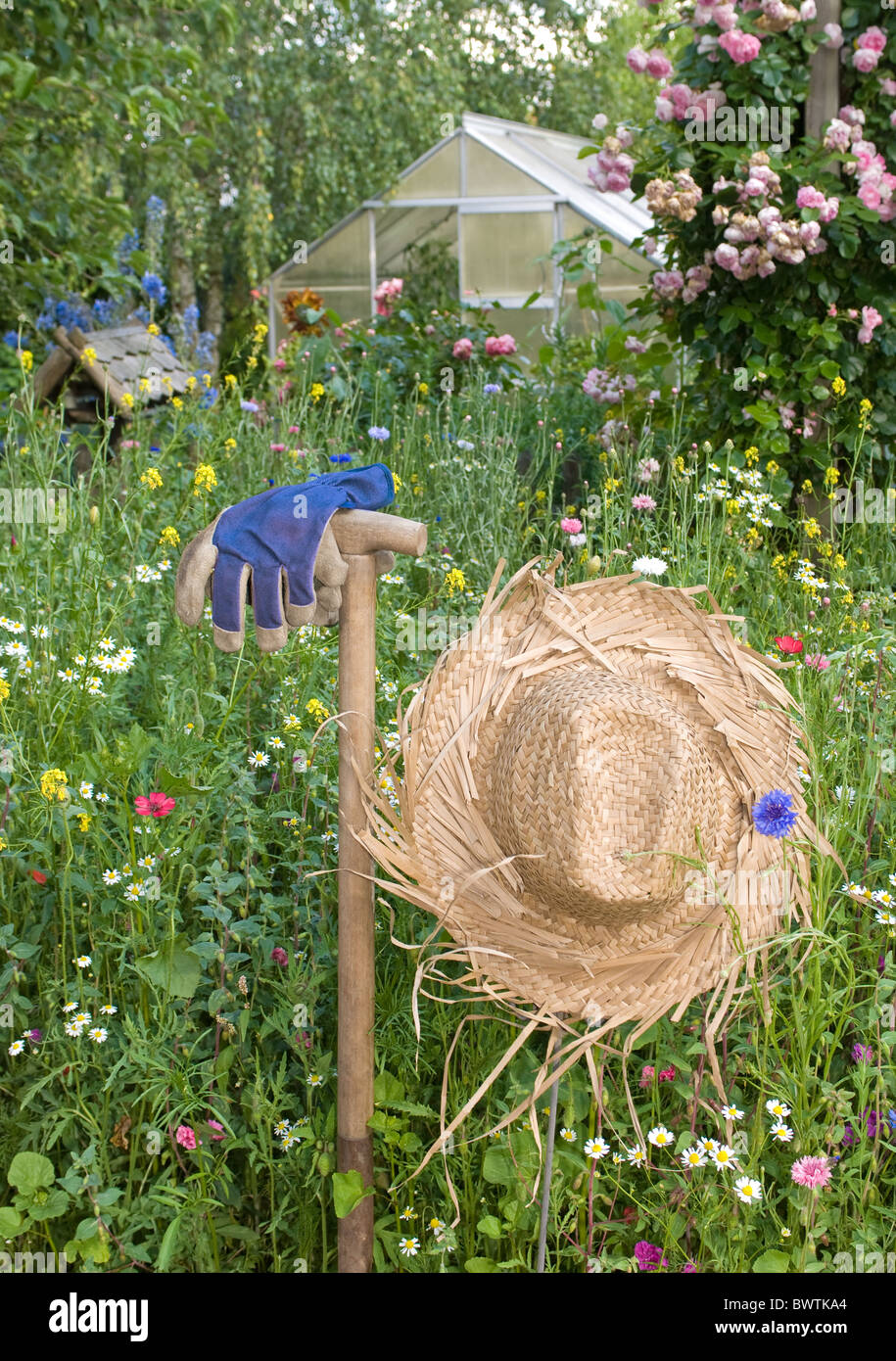 Straw hat in wild meadow Stock Photo