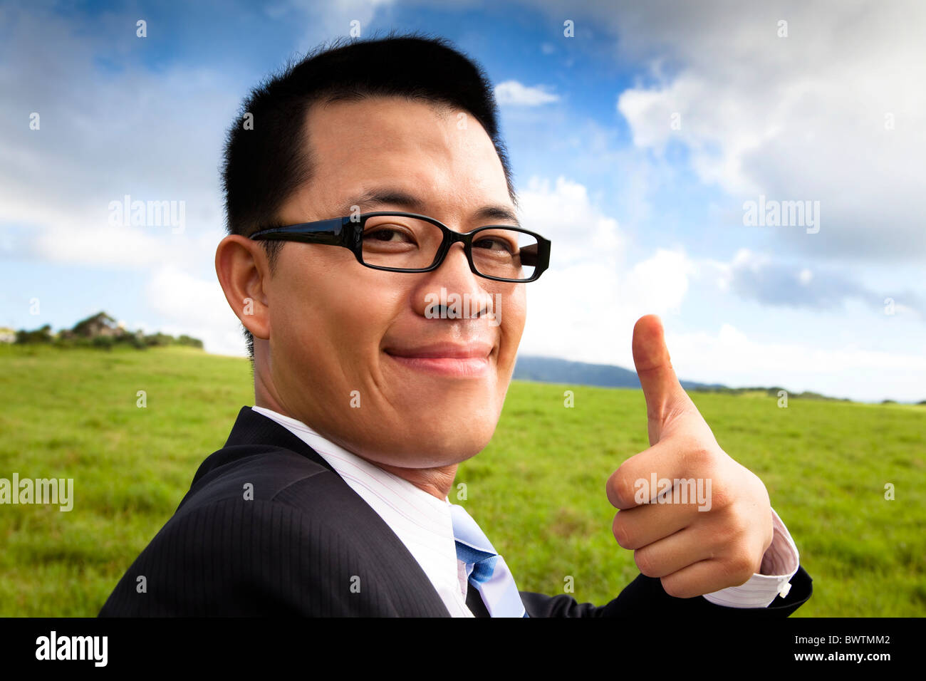 young smiling and confident businessman with thumb up Stock Photo